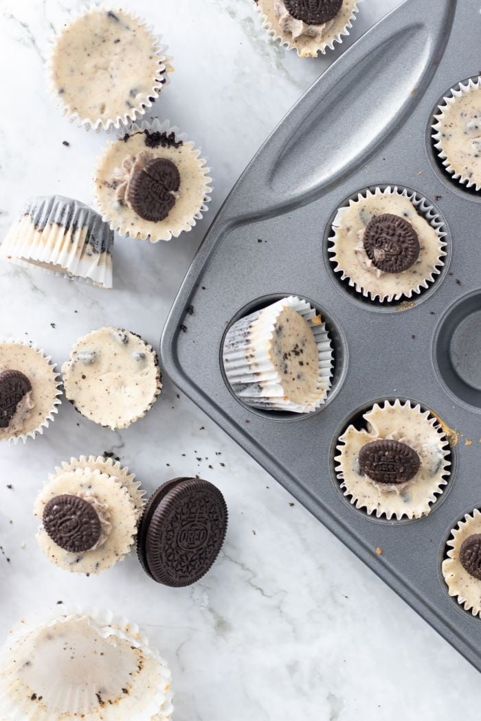 Oreo Cheesecake bites are scattered around the baking pan